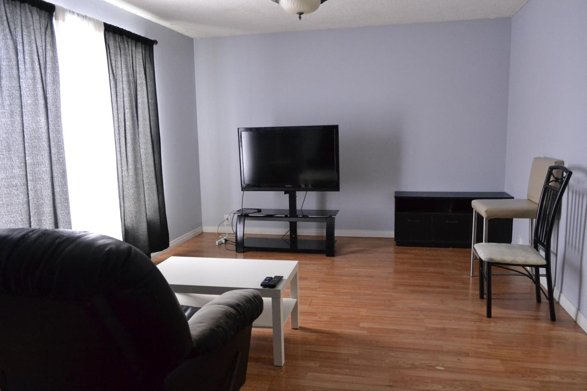 Private Bedroom On The Main Floor With Shared Washroom - Erin Woods Calgary